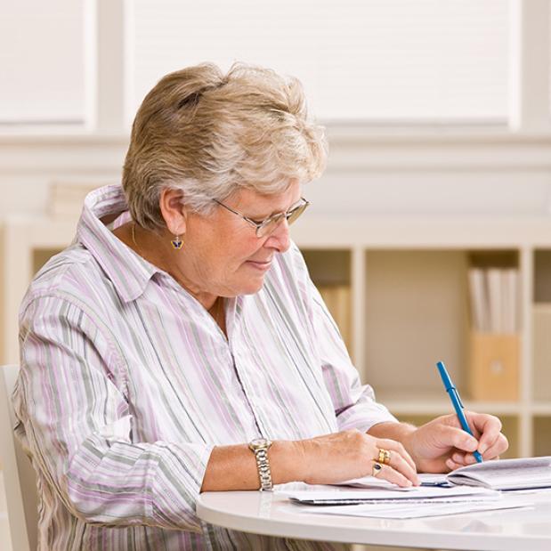 Happy Woman Writing on Paper