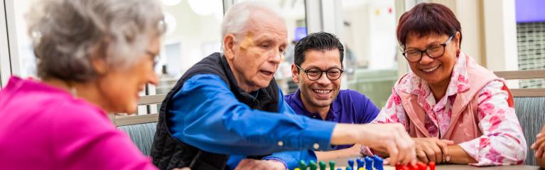 Senior Group and Caregiver Playing Board Game